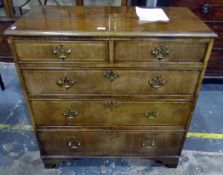 Reproduction walnut straight front chest of two short and three long graduated drawers,