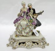 Capodimonte porcelain group of pair of lovers, seated, the gentleman playing mandolin,