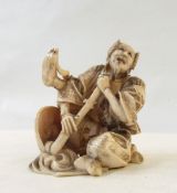 Japanese carved ivory figure of a performer, possibly an acrobat, with fan head dress,