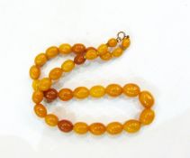 String of graduated amber coloured beads,