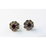 Pair of 18ct gold, ruby and diamond flower-shaped earrings, the centre ruby 4mm diameter,