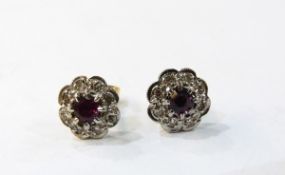 Pair of 18ct gold, ruby and diamond flower-shaped earrings, the centre ruby 4mm diameter,