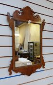 Chippendale style figured walnut wall mirror, with scroll pediment and apron, 75.