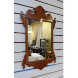 Chippendale style figured walnut wall mirror, with scroll pediment and apron, 75.