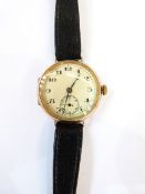 Gent's circular gold-coloured wristwatch with black leather strap