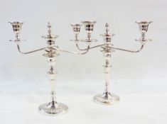 A pair of Georgian style silver plate two light candelabra of typical form.