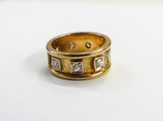 Gold coloured metal & diamond ring, set with 9 diamonds,