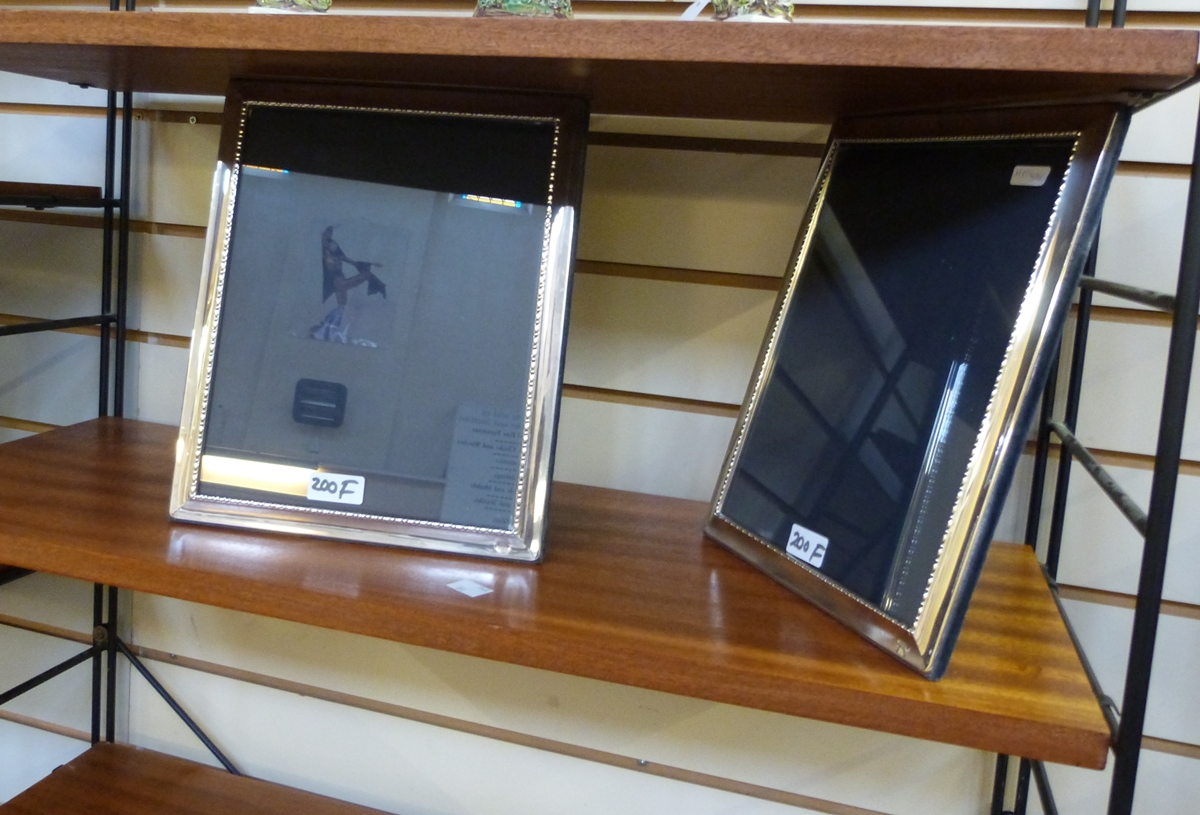 Pair of modern silver-mounted photograph frames, each rectangular with bead and bar border, 25.