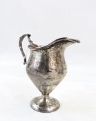 George V silver cream jug, inverse baluster shape, scrolled handle, on circular foot, 10cms high,