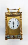 Late 19th/early 20th century French small enamel brass carriage timepiece, having scroll handles,