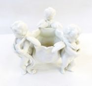 Continental white porcelain tripod flower basket with frilled edge supported by three cherubs