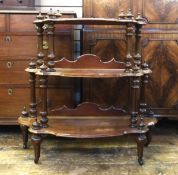 19th century carved mahogany three-tier whatnot, with turned finials, on turned legs and castors,