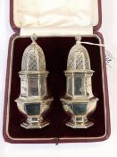 Pair of early 20th century silver pepperettes, London 1926, maker's mark worn, 10.