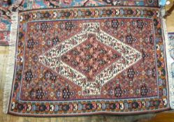 Senneh Kelim rug with central ivory bordered medallion, having stylised flowering plants,