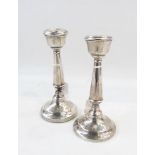 Pair of George V silver candlesticks of tapering cylindrical form, on a raised circular foot,
