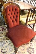 Victorian walnut drawing room chair, the arched buttoned back with floral rosette,