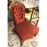 Victorian walnut drawing room chair, the arched buttoned back with floral rosette,