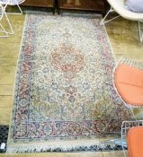 Indo-Persian wool rug with cherry red stylised flowerhead arabesque to the ivory field and allover