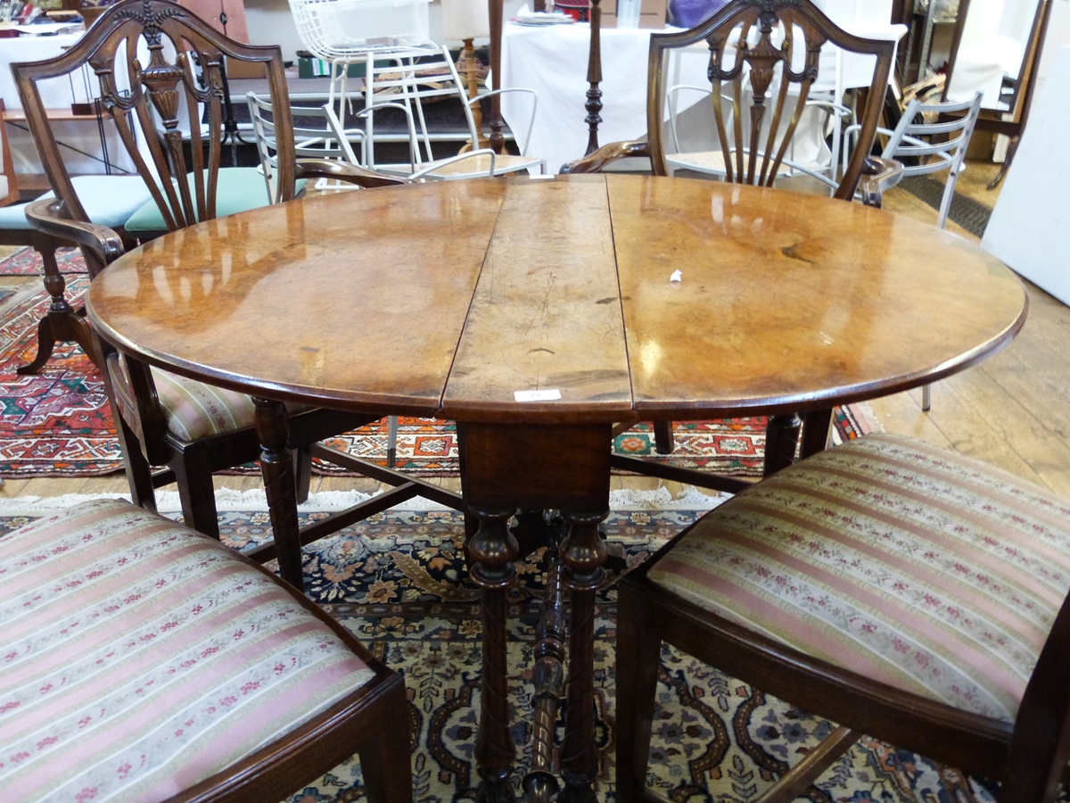 19th century walnut Sutherland table on turned supports united by stretcher,