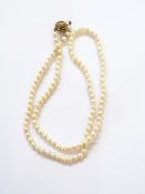 Cultured pearl single strand necklace and the silver gilt pierced whorl-pattern spherical clasp,