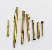 Gold-plated and turquoise propelling pencil with sliding mechanism, four other similar,