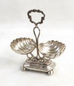 Polish silver coloured metal shell condiment stand, the central scroll handle,