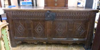 19th century oak coffer with carved front panel and carved legs,