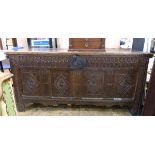 19th century oak coffer with carved front panel and carved legs,