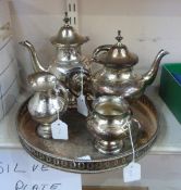 Silver plated four-piece tea service on a circular tray