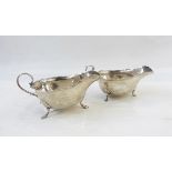 Edwardian silver sauceboat with cut card borders raised on pad feet,