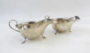 Edwardian silver sauceboat with cut card borders raised on pad feet,