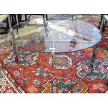 Modern circular glass-topped chrome coffee table,