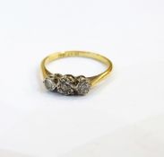 Gold-coloured three-stone diamond ring set with three Swiss cut diamonds and marked 18ct plat.