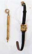 Mid 20th century gold cased wristwatch with black strap and a propelling pencil