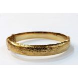 Rolled gold bangle with engraved decoration,