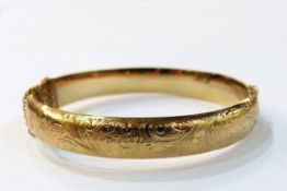 Rolled gold bangle with engraved decoration,