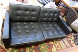 Knoll black leather and chrome two-seater settee, square-backed with button upholstery,