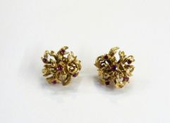 Pair of gold coloured metal and ruby dress earrings, abstract foliate design,