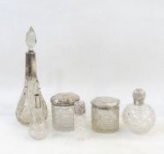 Three cut glass scent bottles with silver mounts,