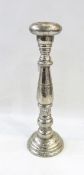 Tall white metal candlestick, a cylindrical canister,