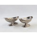 Pair of Victorian silver boat-shaped pedestal salts, reeded pattern, raised on oval foot,