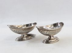 Pair of Victorian silver boat-shaped pedestal salts, reeded pattern, raised on oval foot,