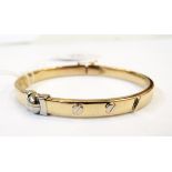 Gold and white coloured metal hollow bangle in the style of Cartier,