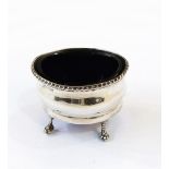 Edwardian silver mustard, oval, with serpentine sides, gadrooned everted rim, on ball and claw feet,