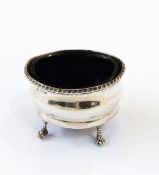 Edwardian silver mustard, oval, with serpentine sides, gadrooned everted rim, on ball and claw feet,