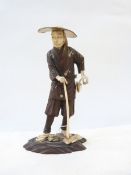 Japanese carved wood, ivory and mother-of-pearl figure of a woodcutter, having ivory head, hands,