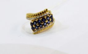 An 18ct gold sapphire and diamond modern cluster ring, 5.