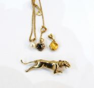 Gold coloured brooch of a leaping big cat with a gemset eye, marked 375,