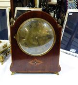 Early 20th century inlaid and stained wood bucket-style mantel clock having broken arch top with