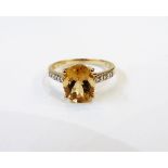 9ct gold, citrine and diamond ring, the citrine raised clasp with sloping shoulders,